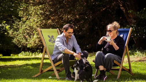 A couple enjoys tea in on the lawns outside the Old Rectory at Wimpole Estate, Cambridgeshire